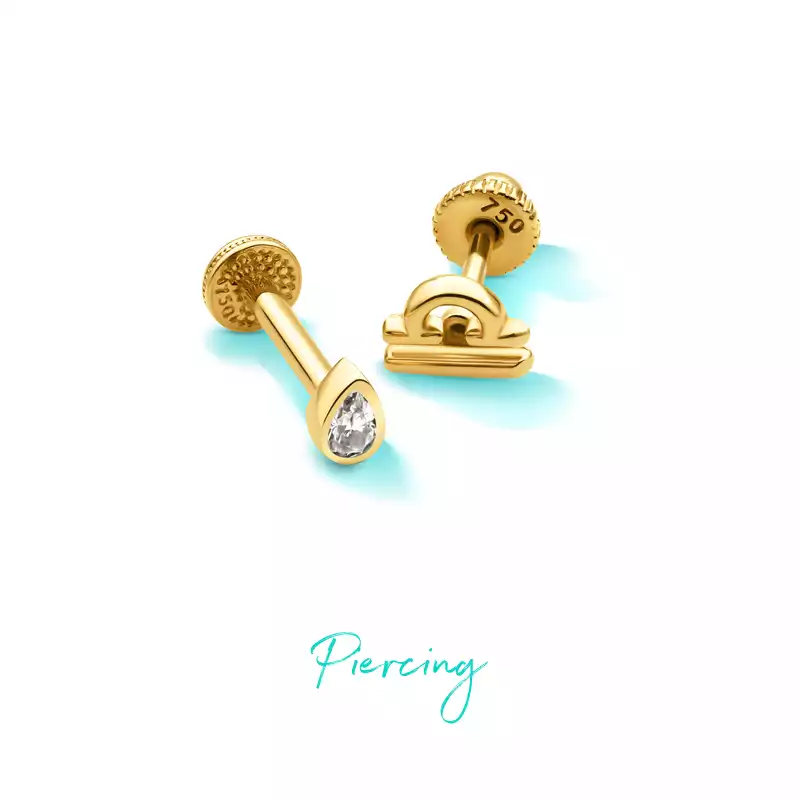 Gold piercing with a teardrop-shaped gem, suitable for use in the ear or nose.